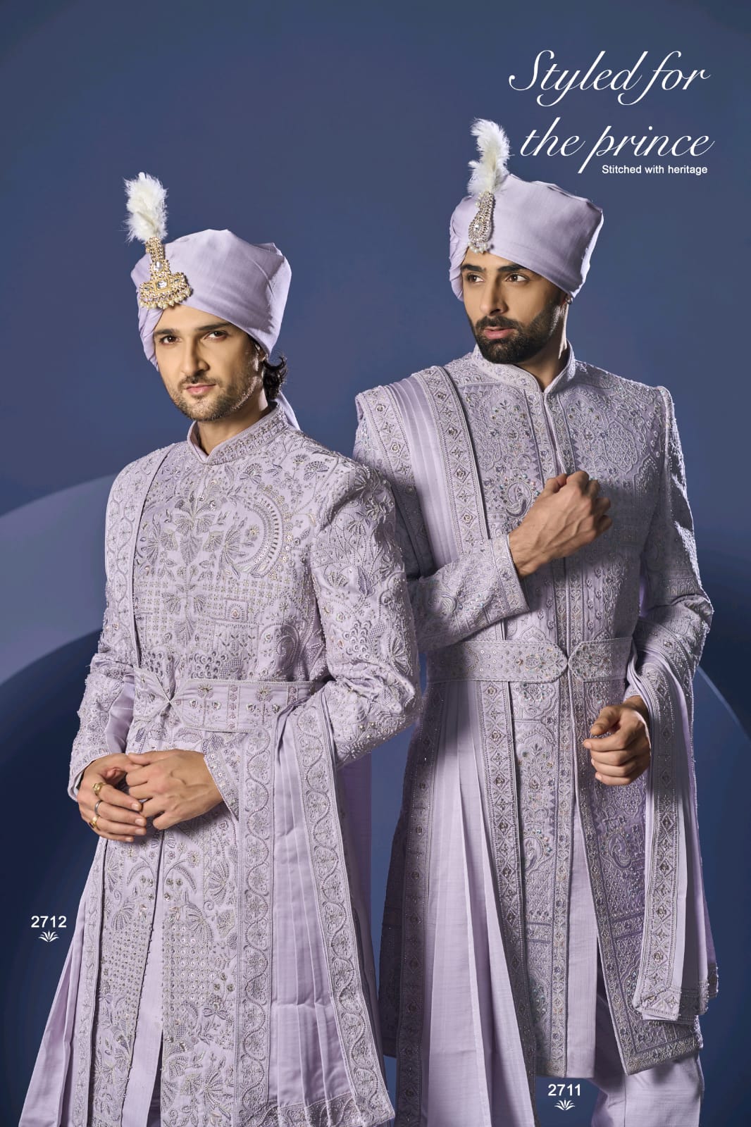 Two men in traditional embroidered suits with turbans against a blue background.