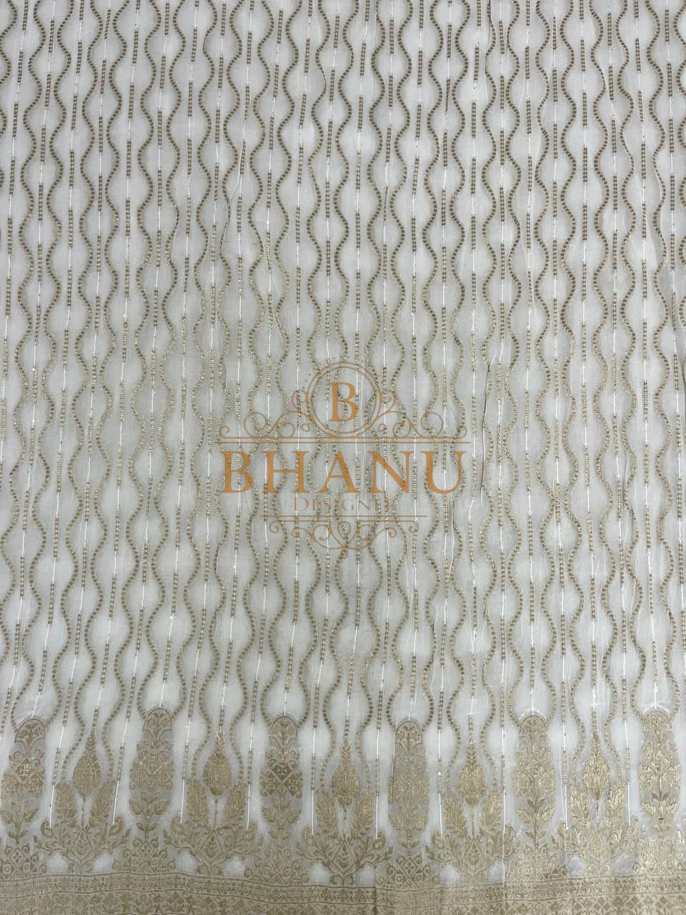 Ivory with wavy gold columns above a worked border - fabric by the metre