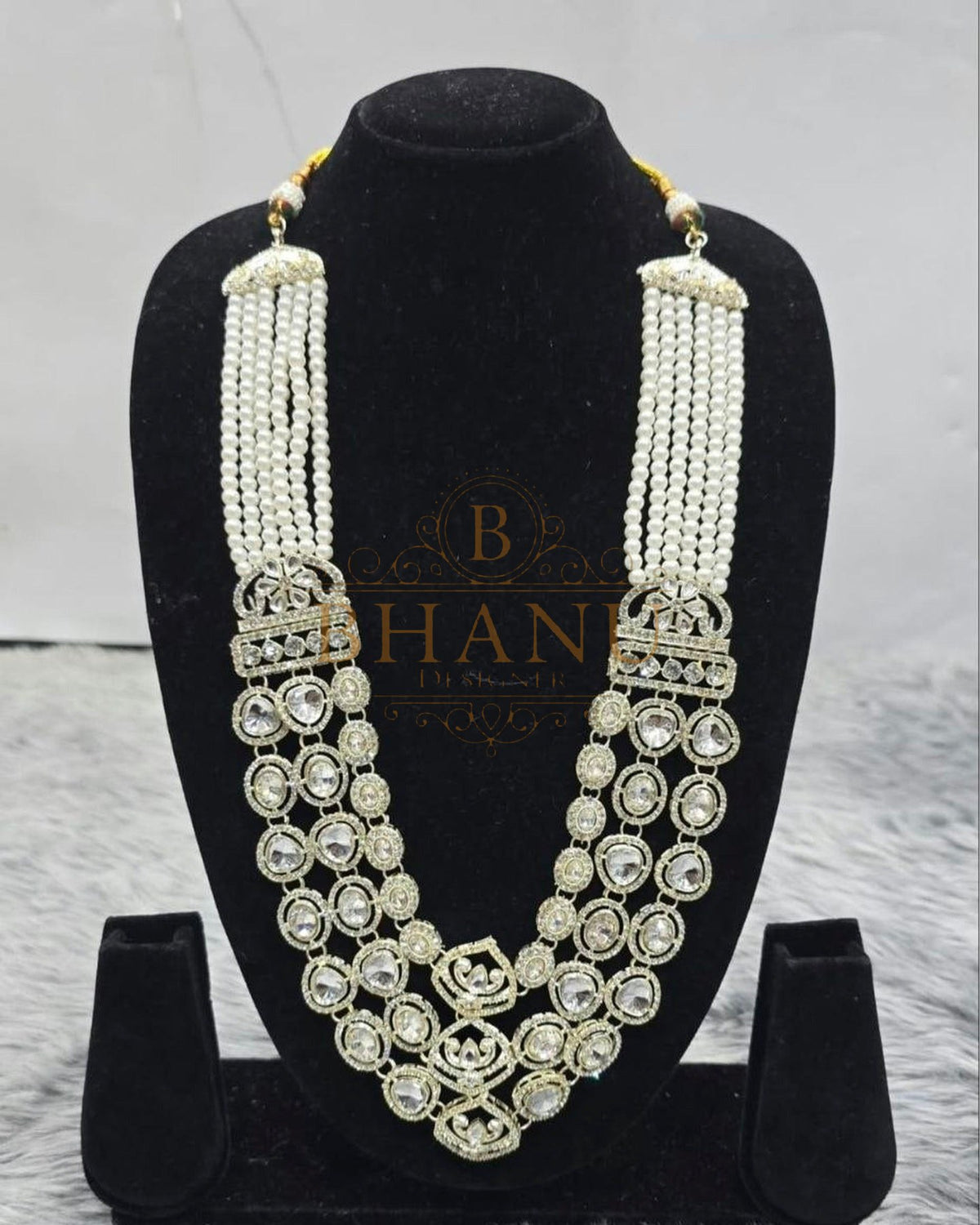 Mala necklace shown on a display stand