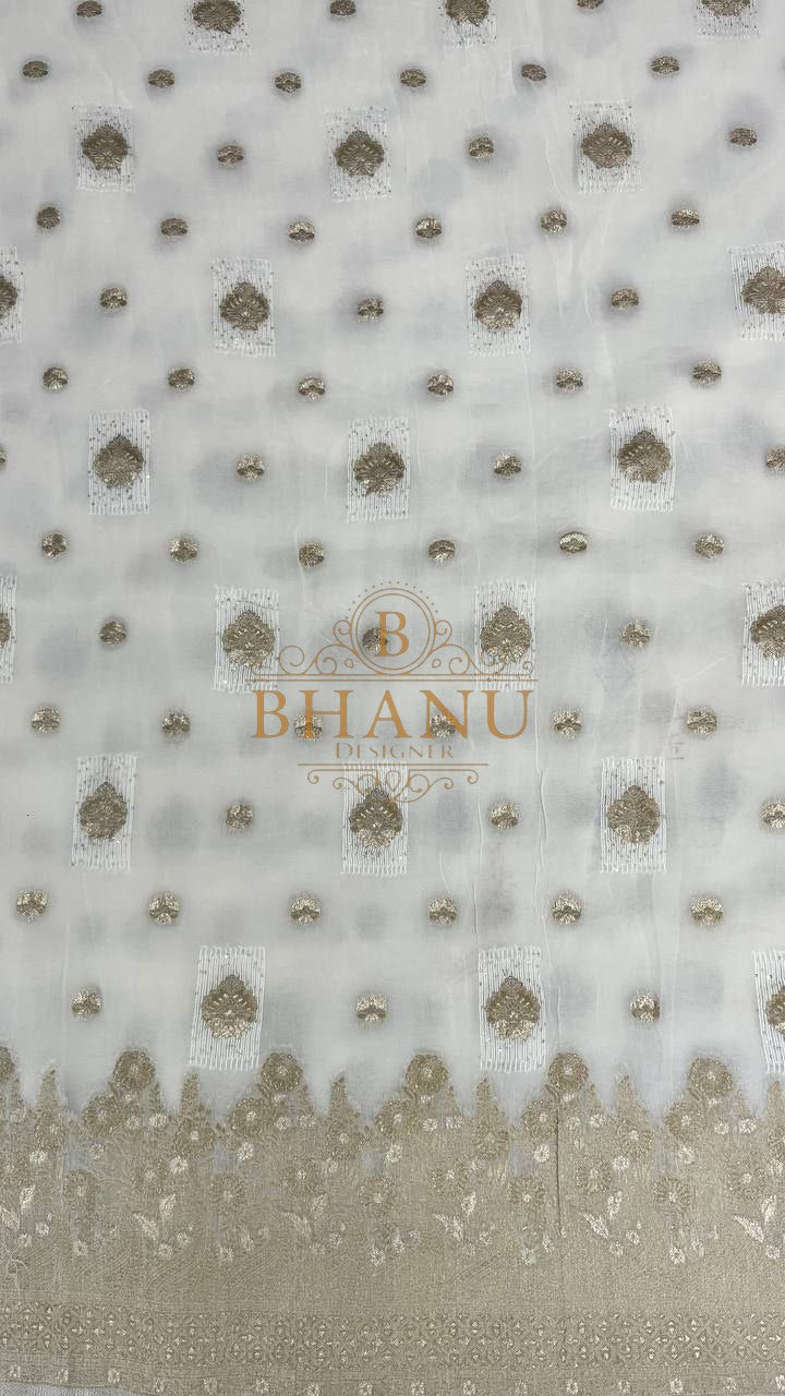 Ivory with gold butti and a woven border - fabric by the metre
