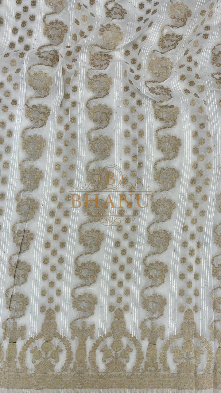 Ivory with gold column work and an arched hem - fabric by the metre