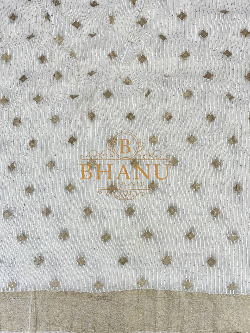 Ivory with fine gold butti and a border - fabric by the metre