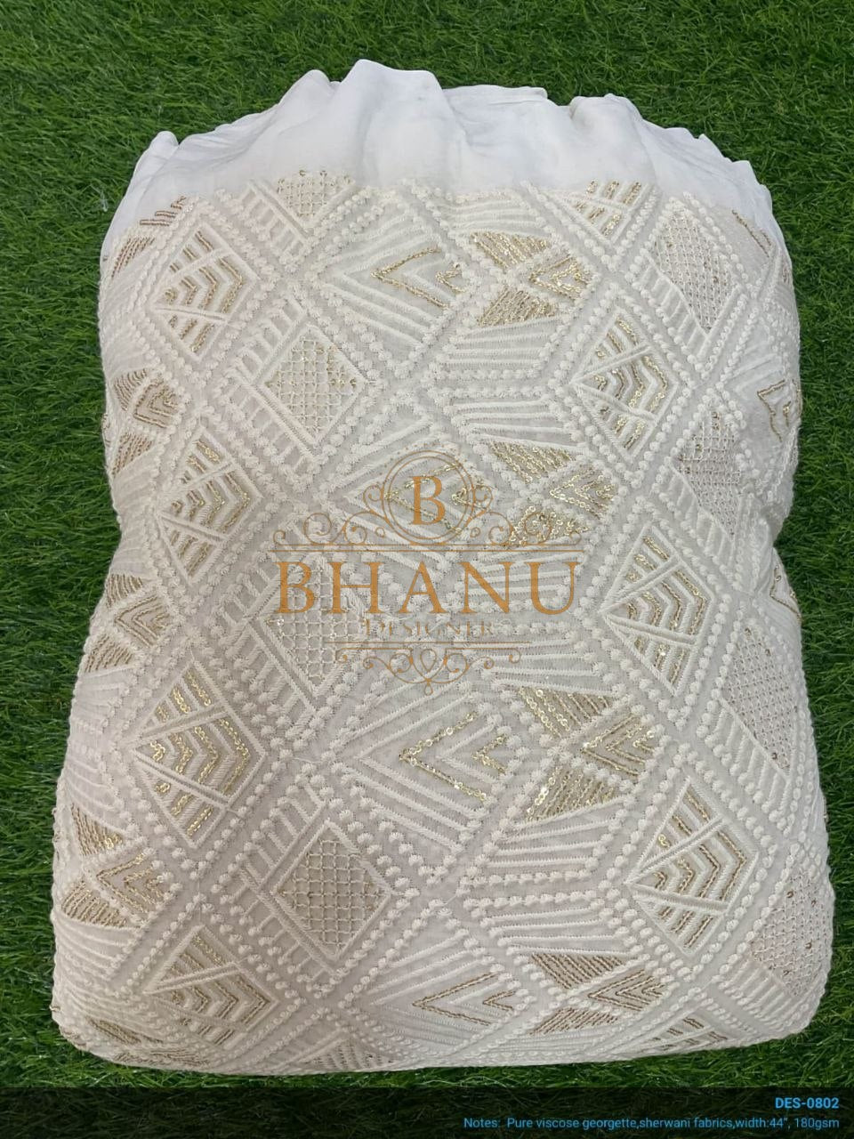 Ivory with geometric cutwork, folded - fabric by the metre