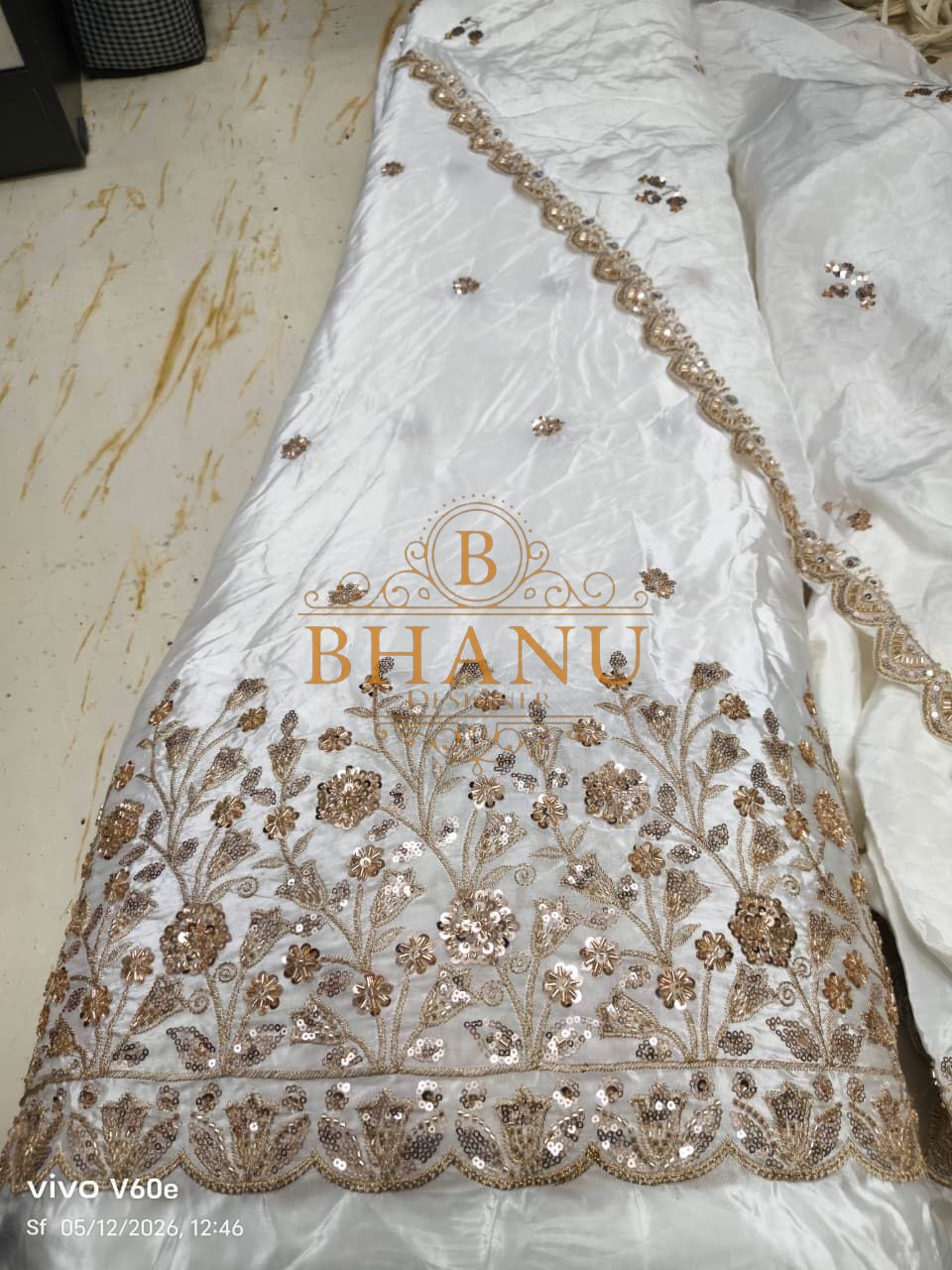 White satin with a gold sequin hem - fabric by the metre