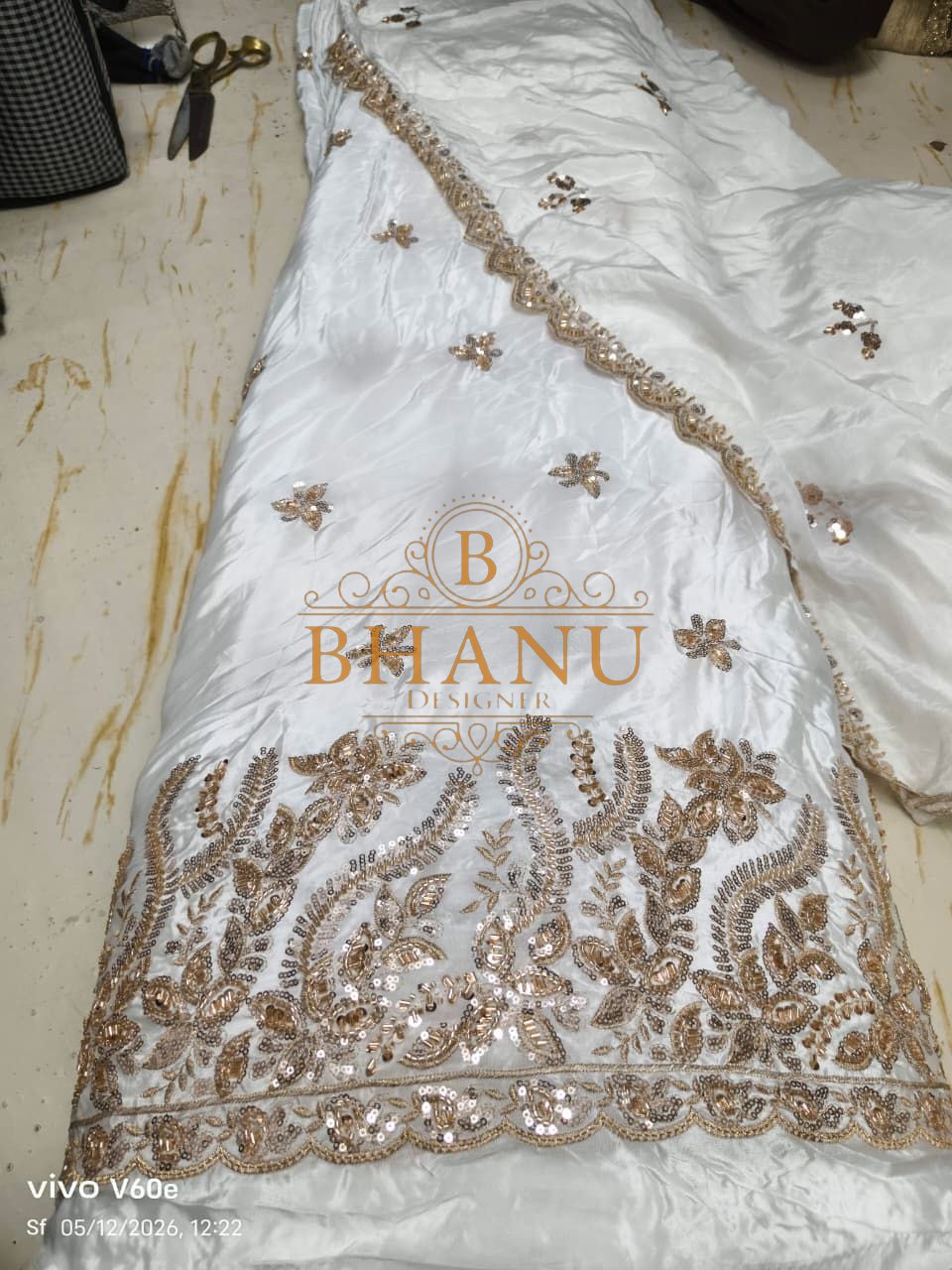 White satin with a gold floral hem - fabric by the metre