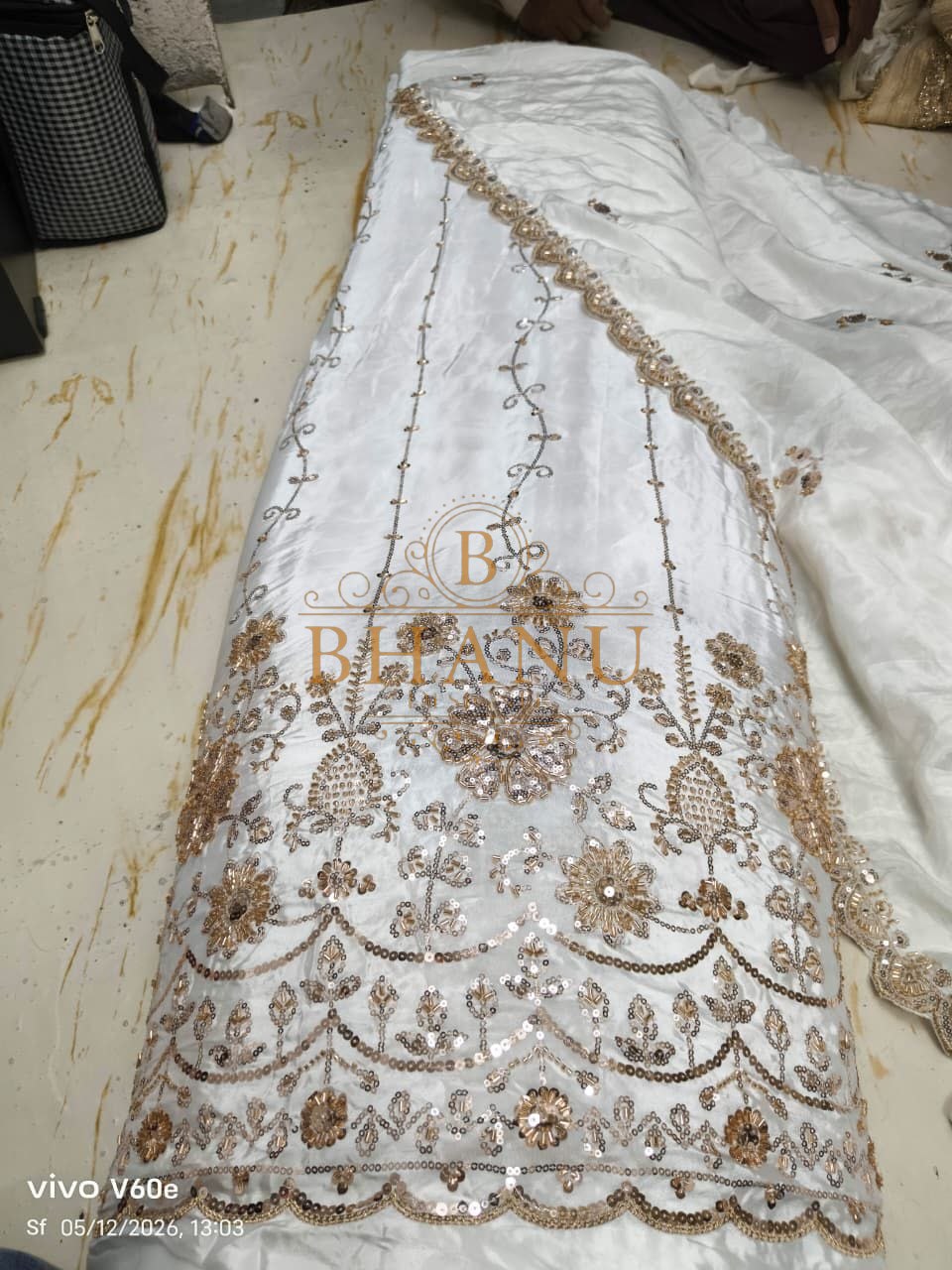 White satin with a gold floral hem - fabric by the metre