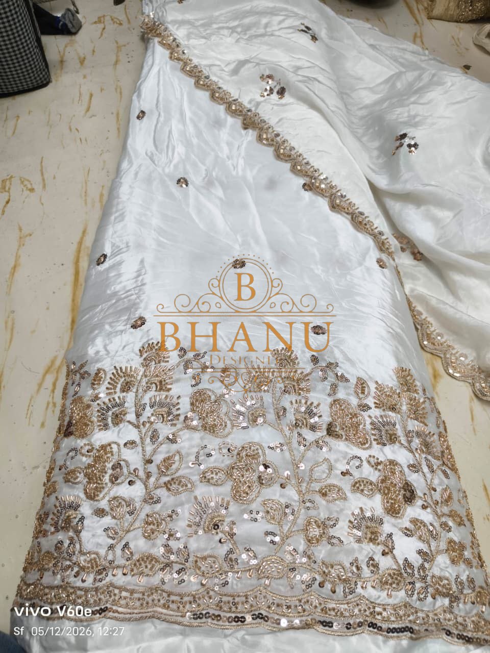 White satin with a gold sequin hem - fabric by the metre