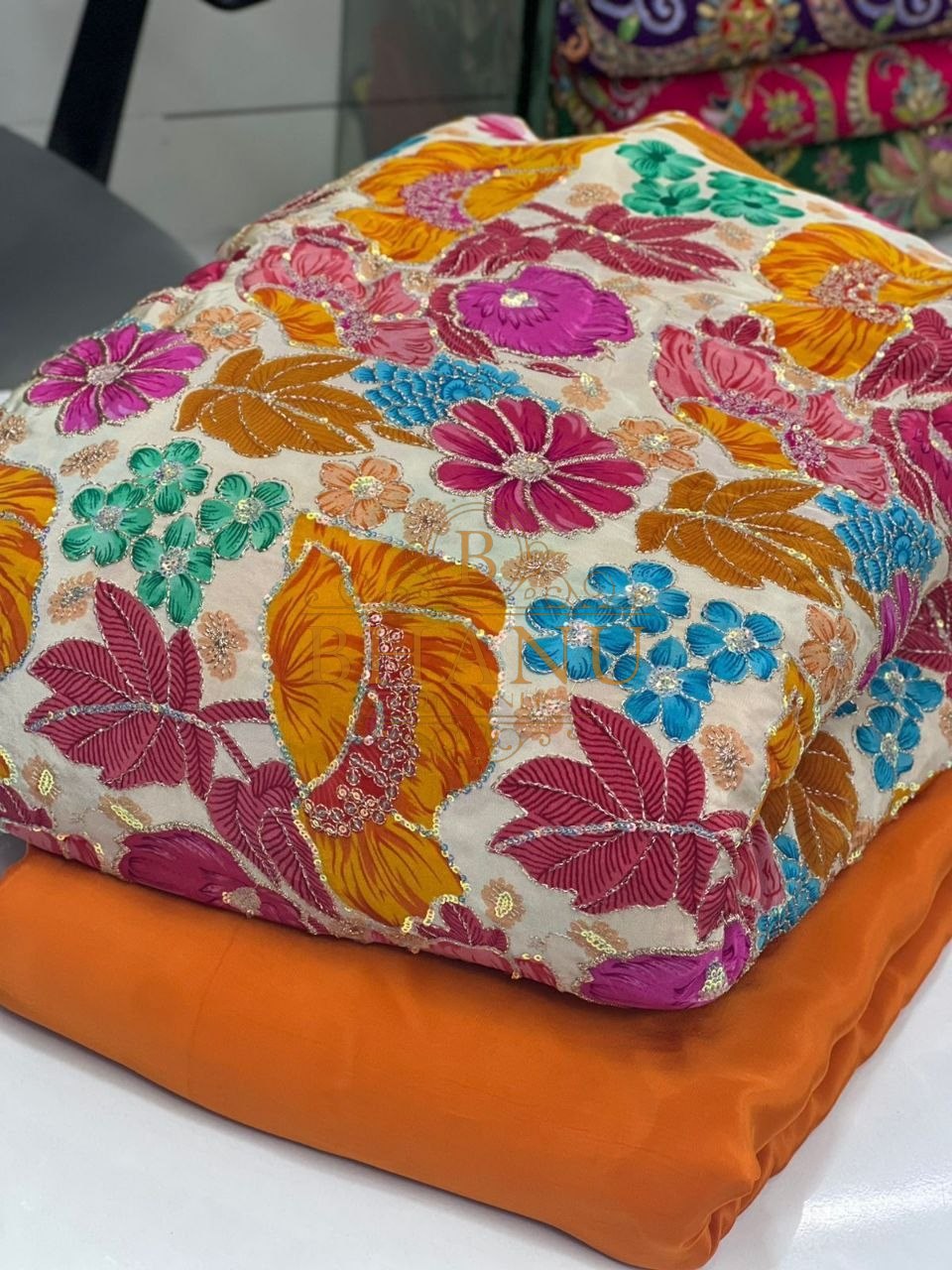 Orange and cream with multicolour floral - fabric by the metre