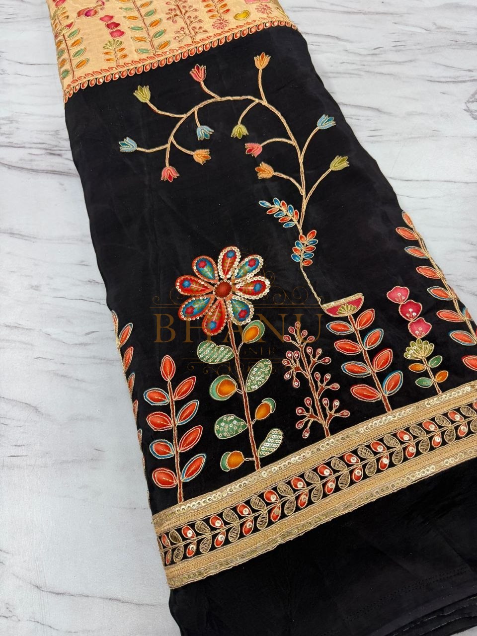 Black with multicolour floral and a gold border - fabric by the metre