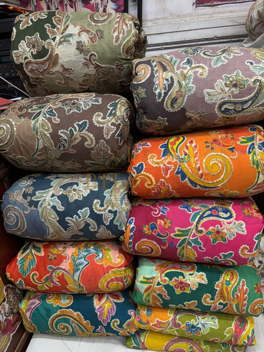 Rolls of printed paisley fabric in many colours