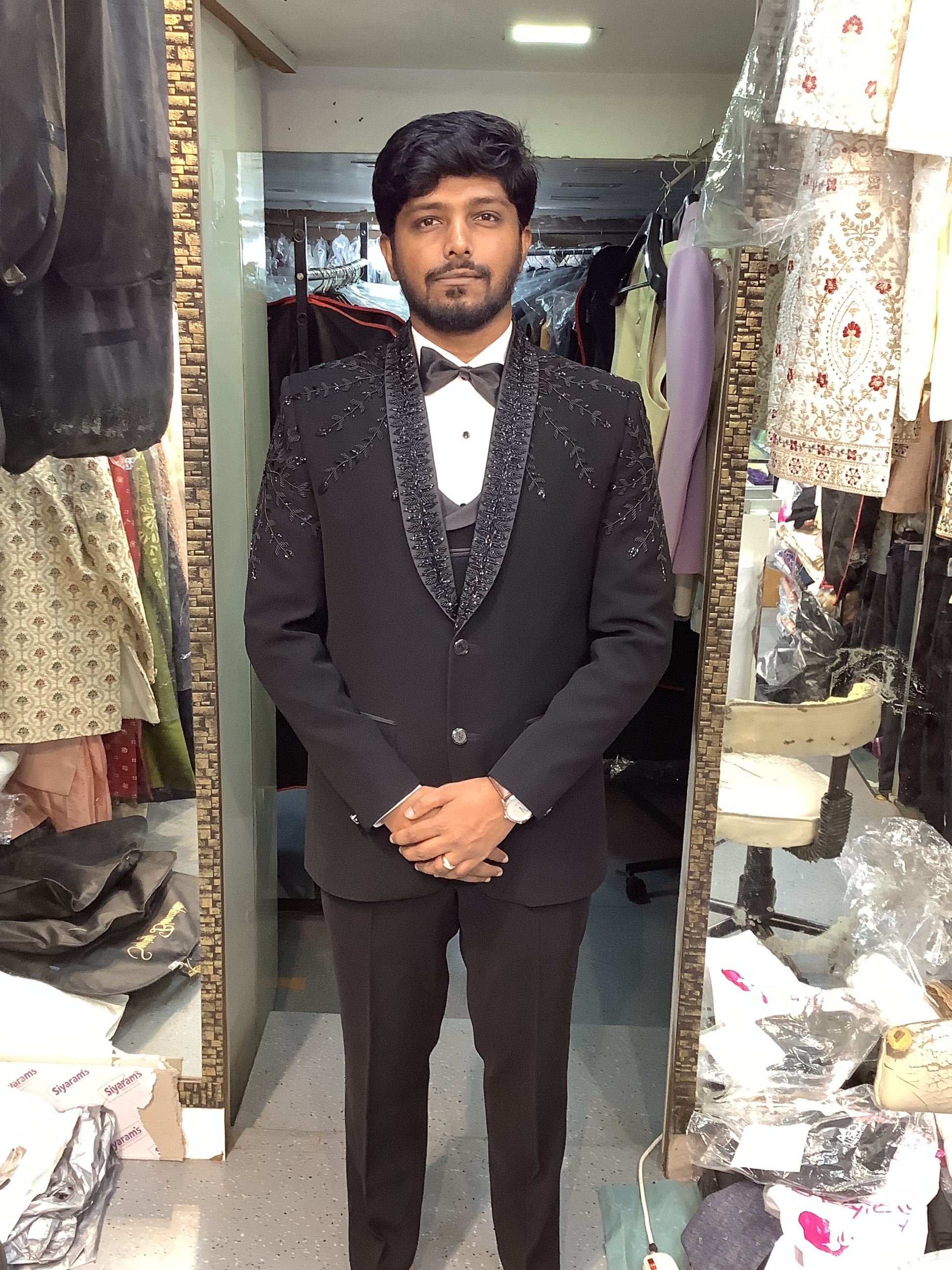 Man wearing a dark coat standing at bhanu designer