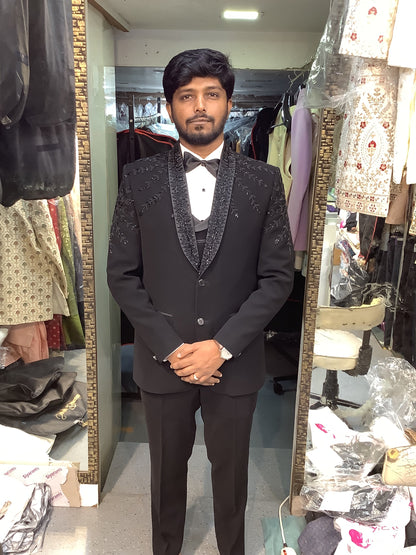 Man wearing a dark coat standing at bhanu designer