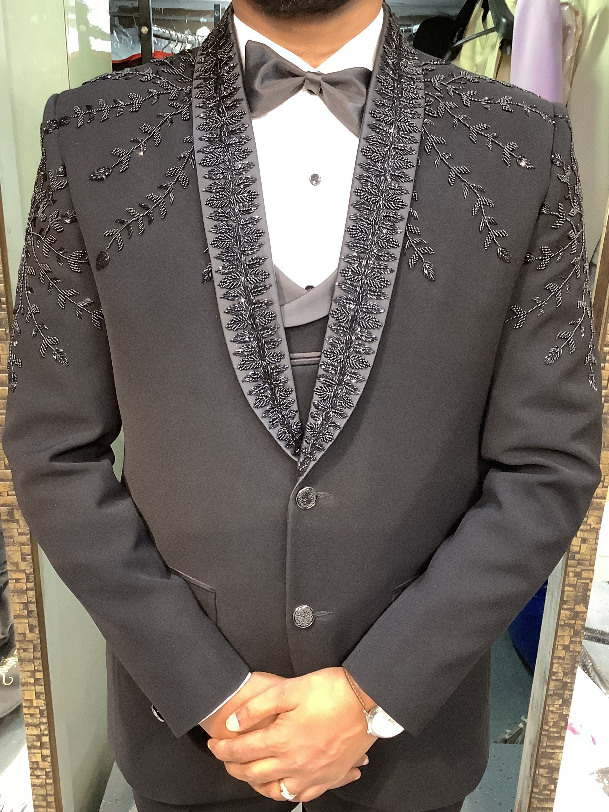 Dark gray embroidered jacket worn by a person at bhanu designer