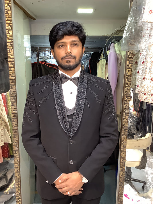Man wearing a dark suit with a patterned vest at bhanu designer