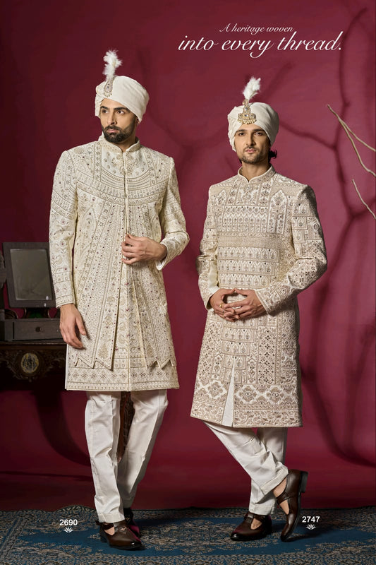 Two men in traditional embroidered sherwanis against a maroon background