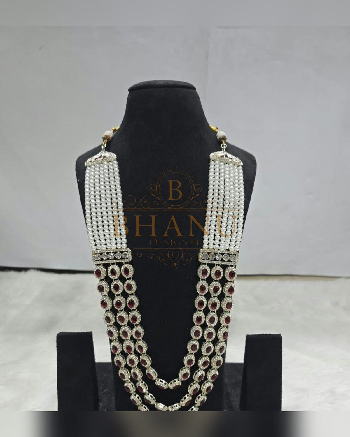 Mala necklace shown on a display stand