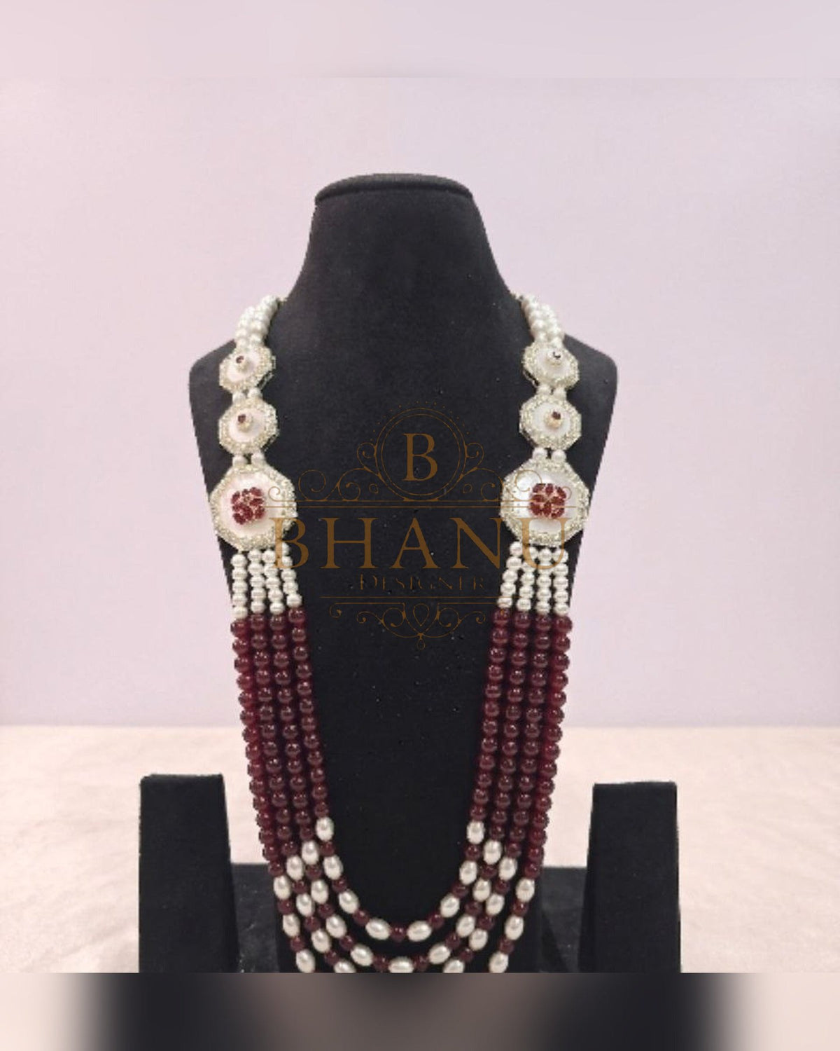 Mala necklace shown on a display stand