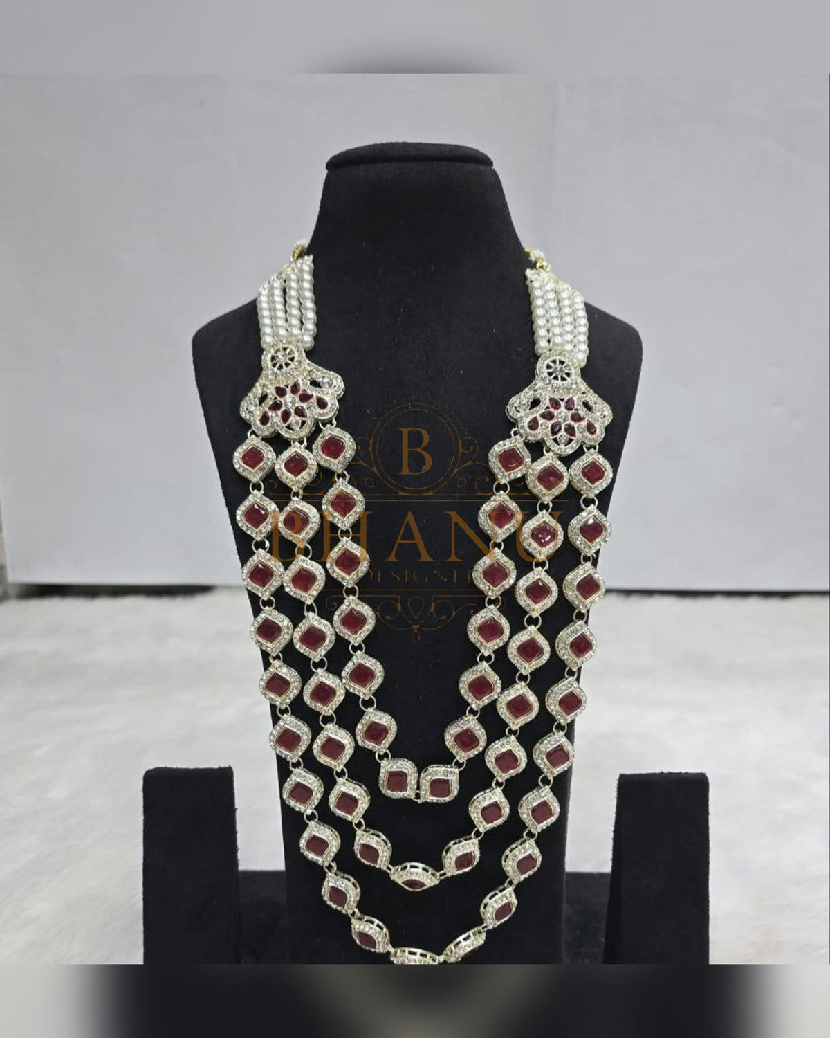 Mala necklace shown on a display stand