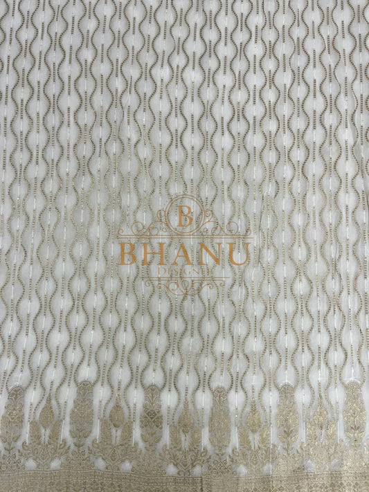 Ivory with wavy gold columns above a worked border - fabric by the metre