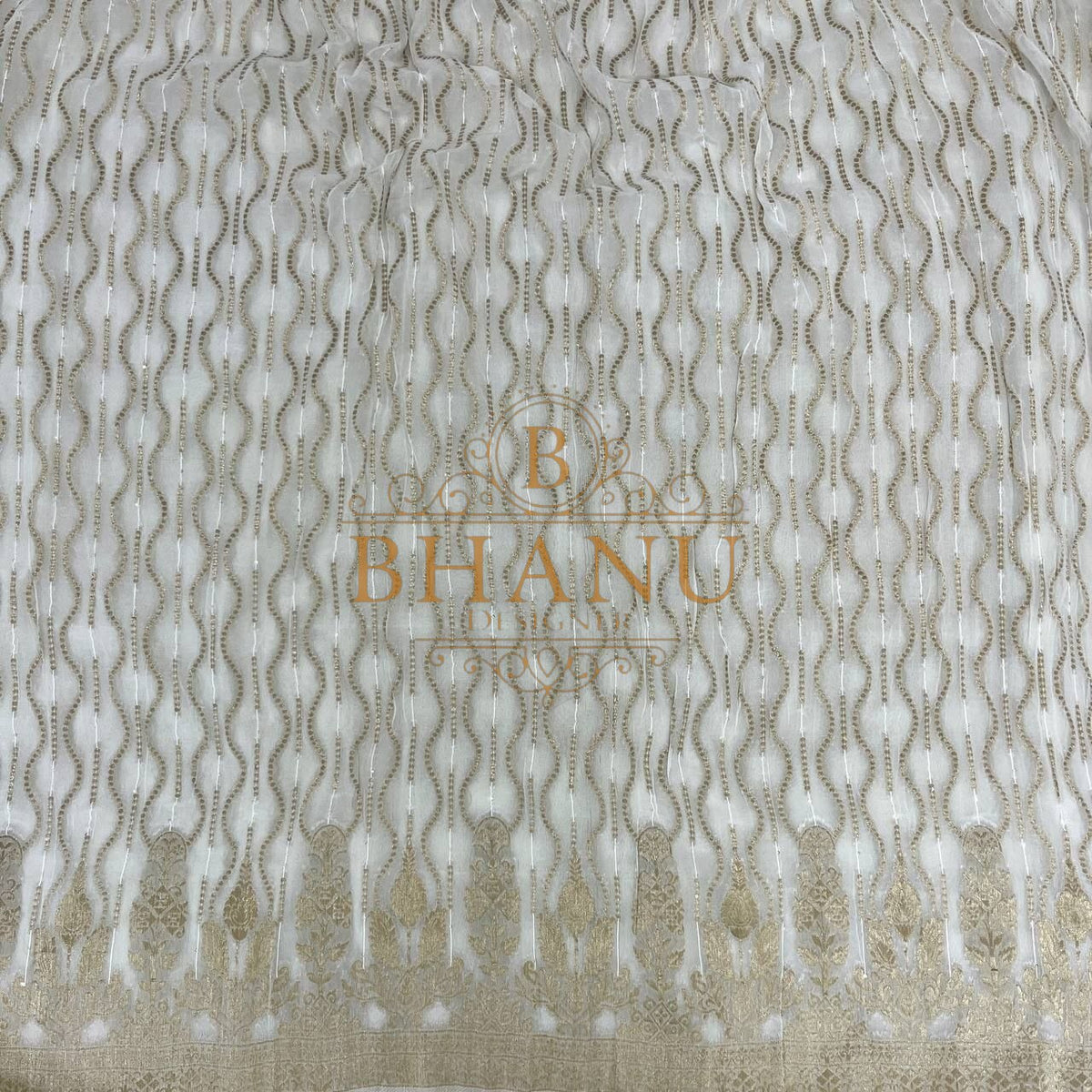 Ivory with fine gold wave and scatter work - fabric by the metre