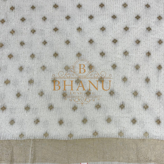 Ivory with gold diamond butti above a woven border - fabric by the metre