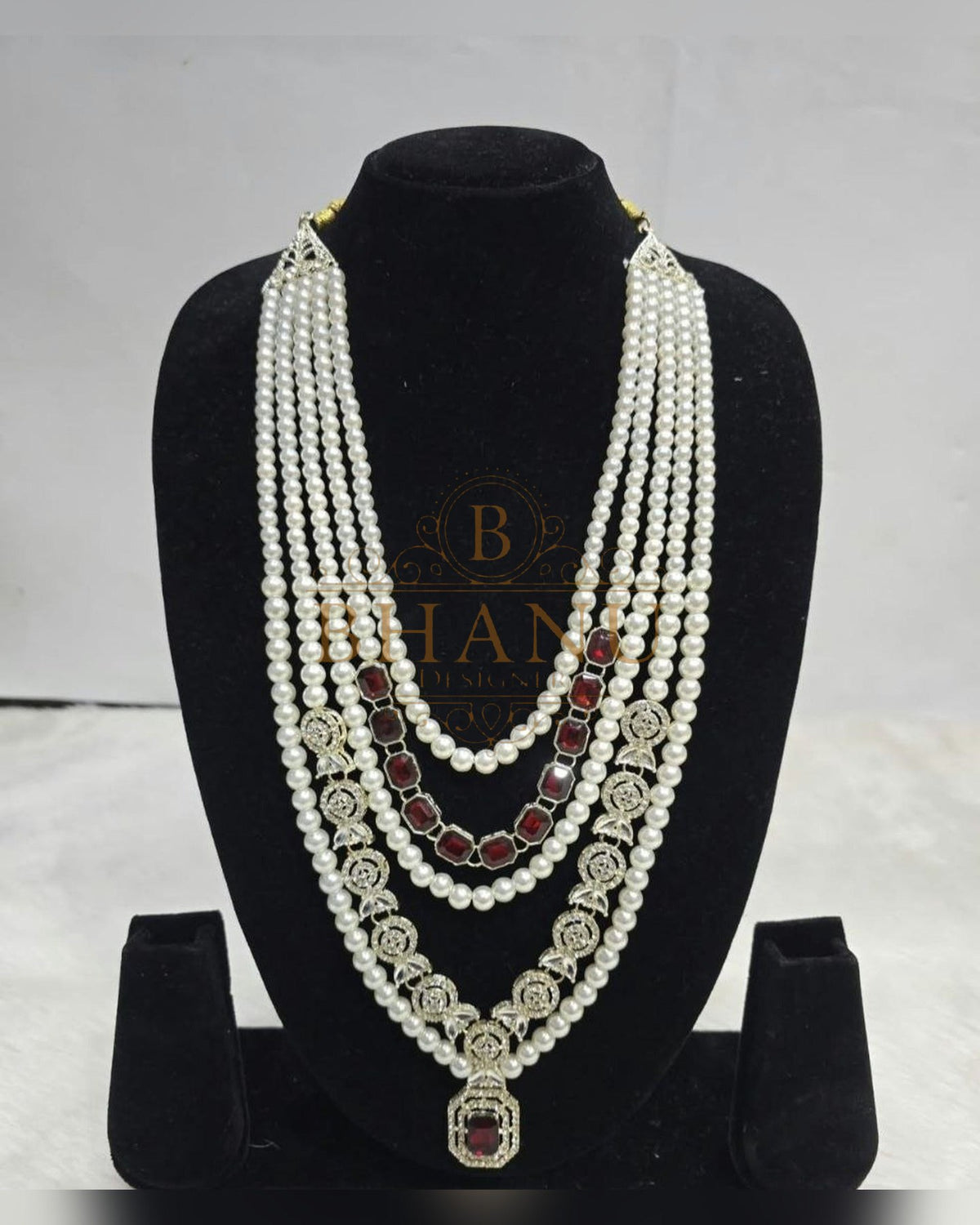 Mala necklace shown on a display stand