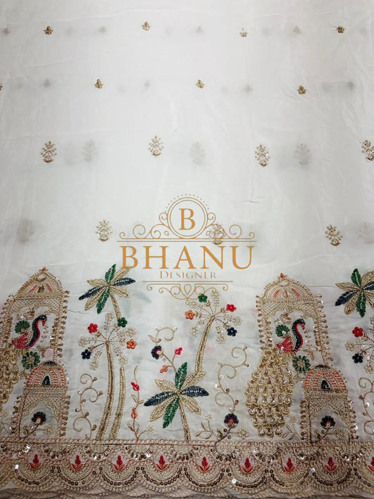 Cream with peacock and tree embroidery along the hem - fabric by the metre