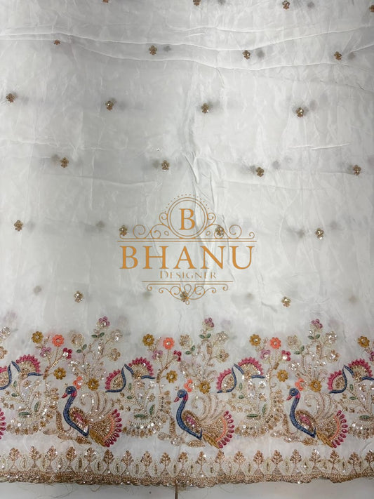 Ivory with fine butti and a peacock border - fabric by the metre