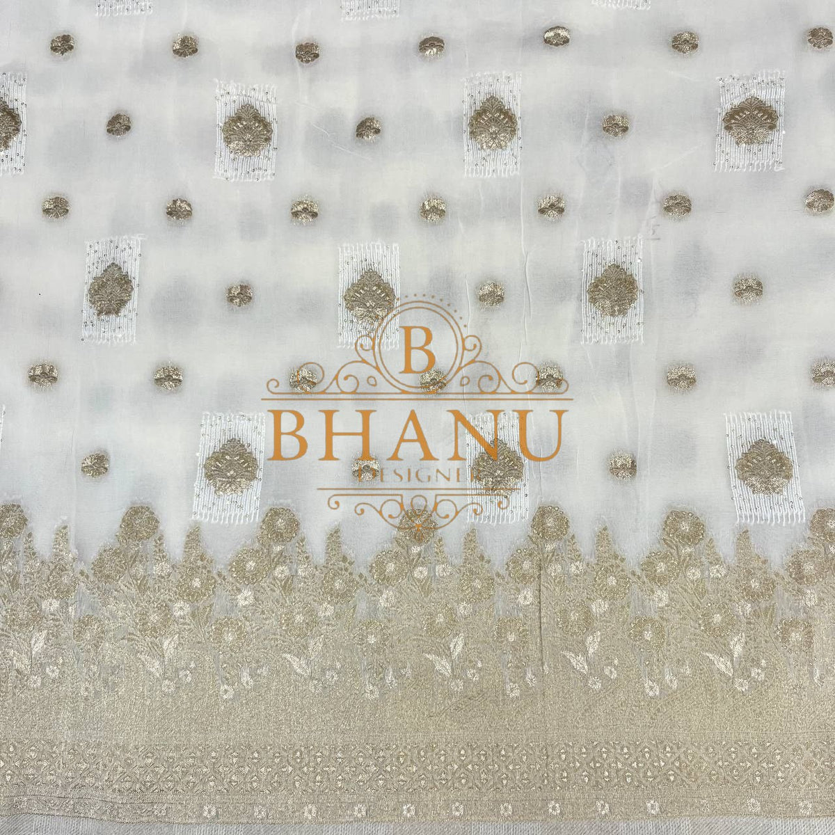 Ivory with gold butti and a scalloped border - fabric by the metre