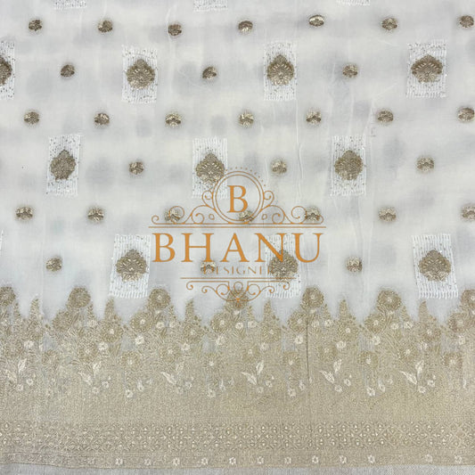 Ivory with gold butti and a scalloped border - fabric by the metre