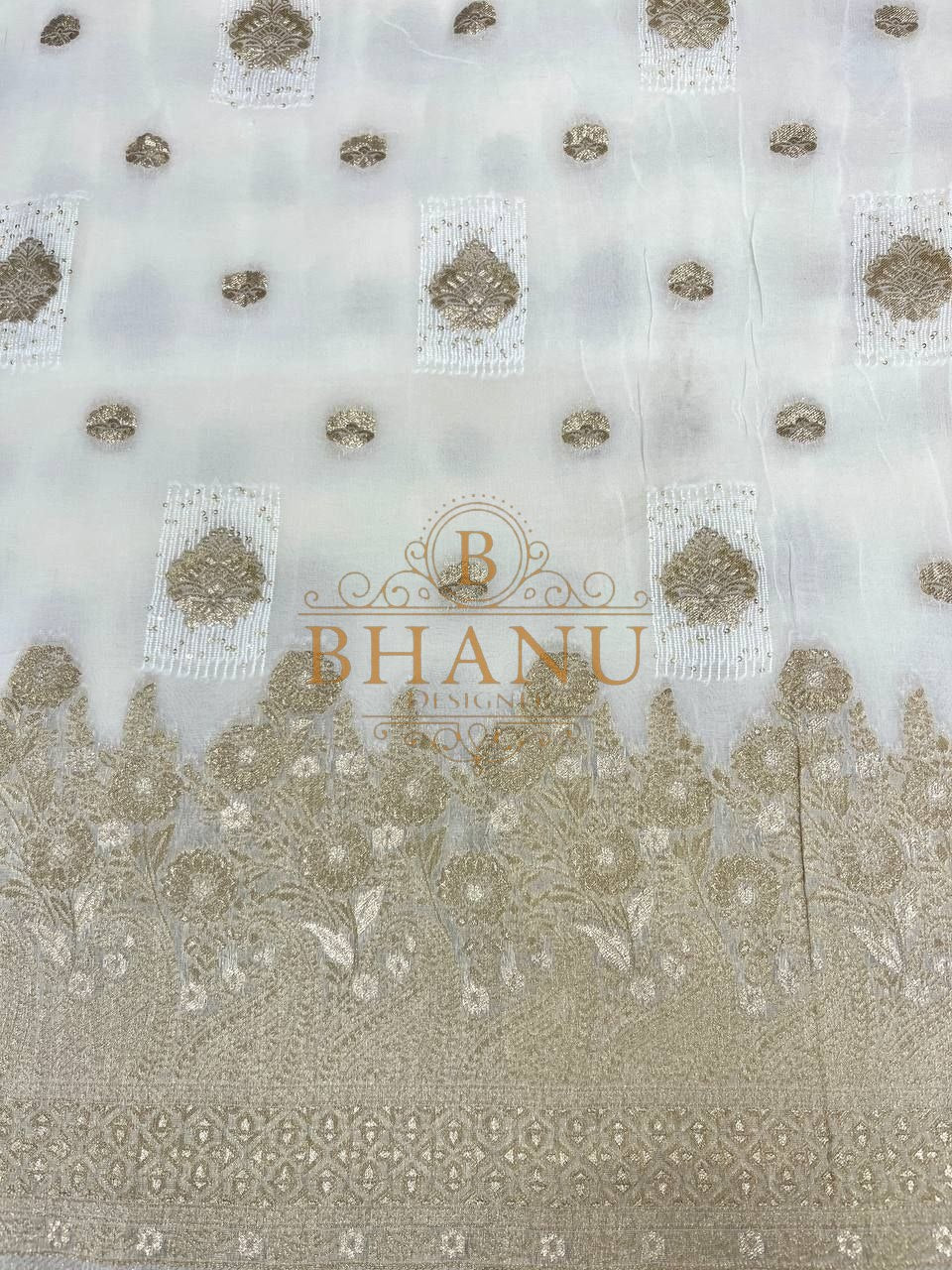 Ivory with gold butti above a heavy border - fabric by the metre