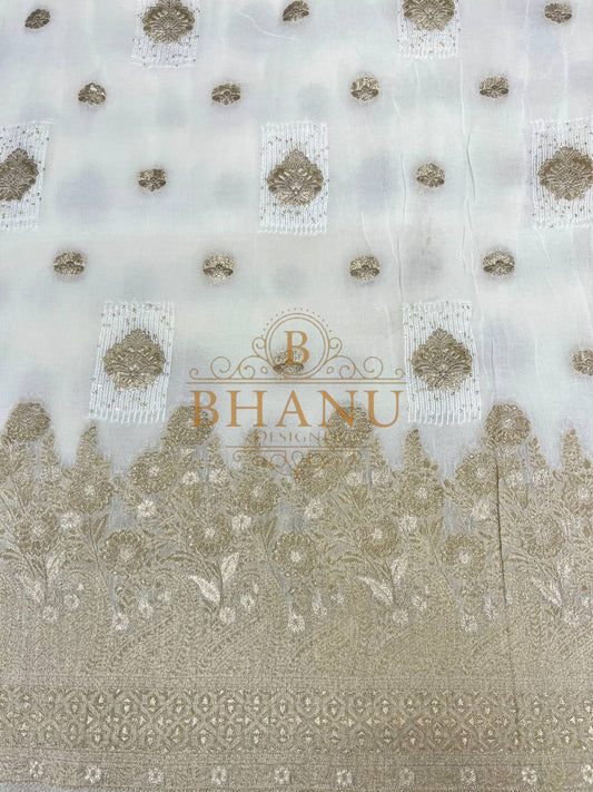 Ivory with gold butti above a heavy border - fabric by the metre