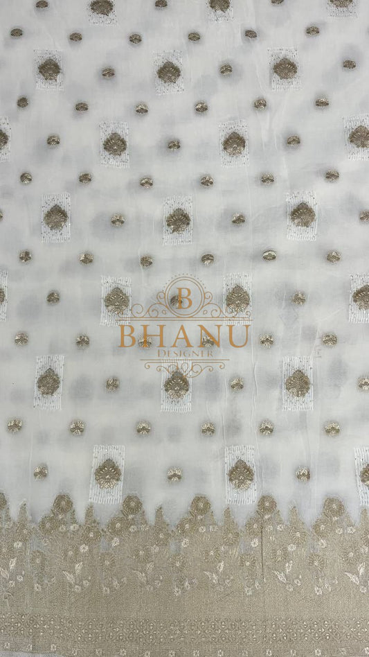 Ivory with gold butti and a woven border - fabric by the metre