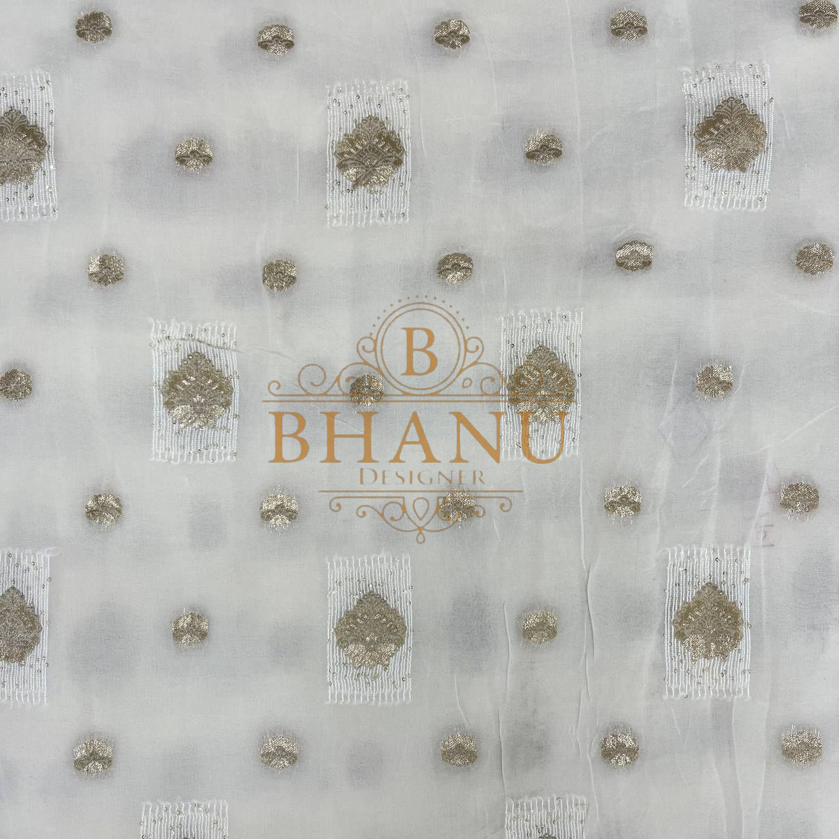 Ivory with gold butti and a worked hem - fabric by the metre