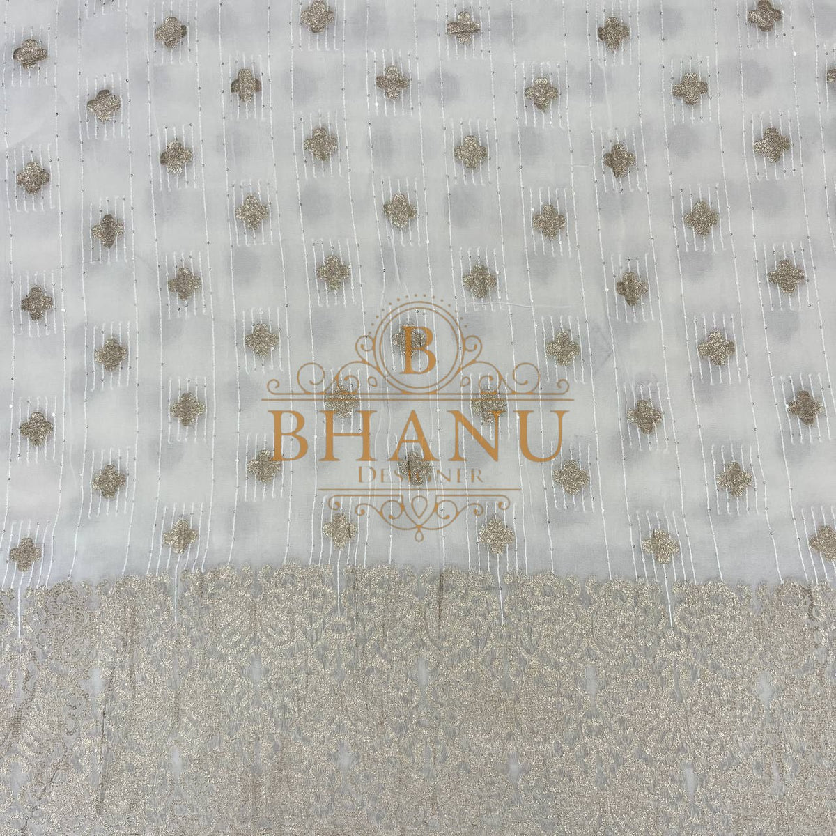 Ivory with gold butti and a woven border - fabric by the metre