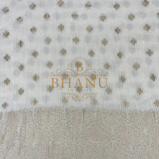 Ivory with gold butti and a woven border - fabric by the metre
