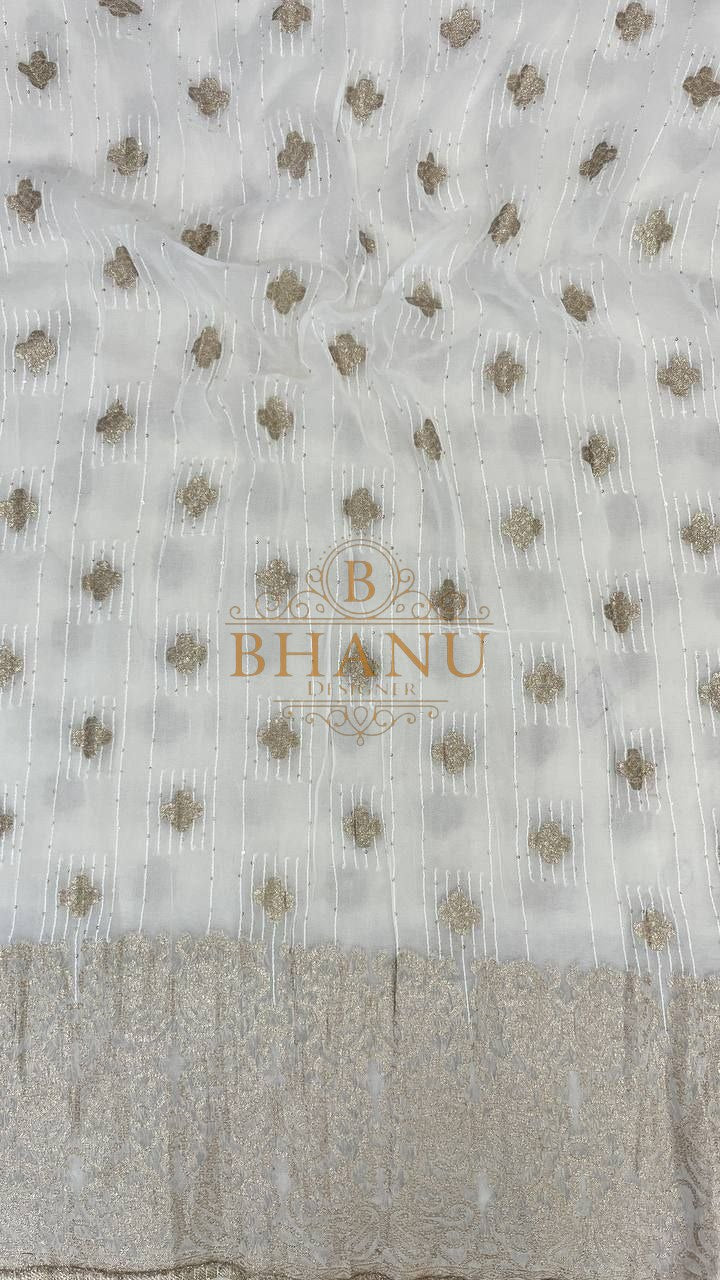 Ivory with gold butti and a woven hem - fabric by the metre