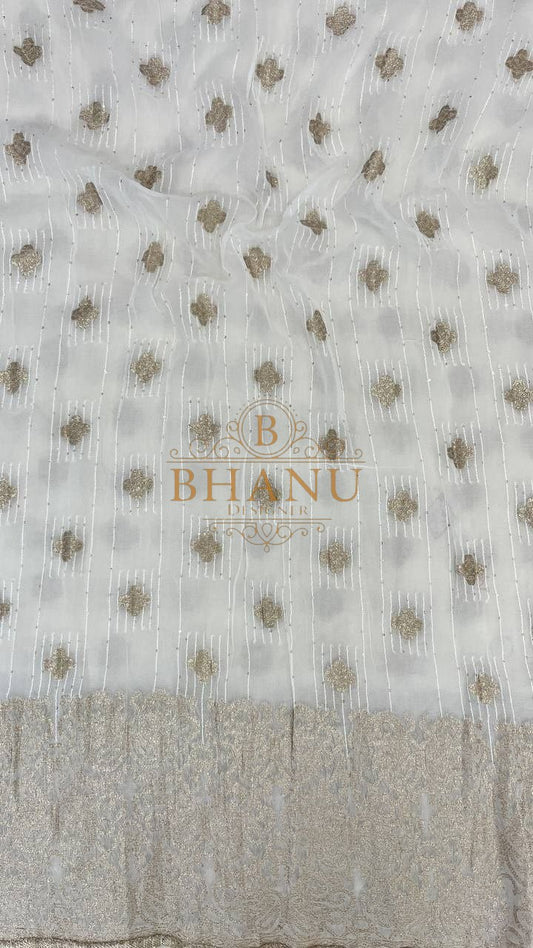 Ivory with gold butti and a woven hem - fabric by the metre