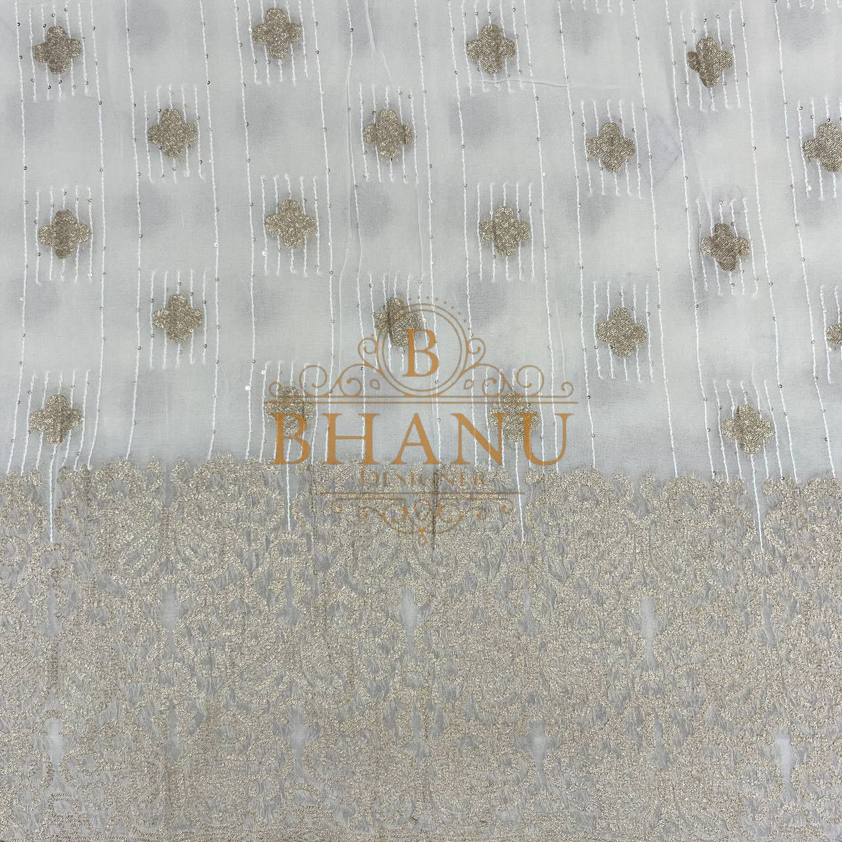 Ivory with gold butti above a heavy woven border - fabric by the metre
