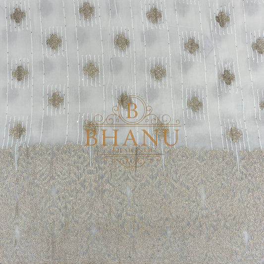 Ivory with gold butti above a heavy woven border - fabric by the metre