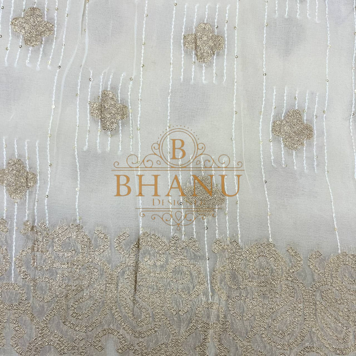 Ivory with gold floral butti and a worked border - fabric by the metre