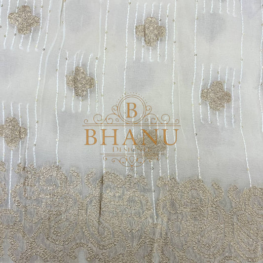 Ivory with gold floral butti and a worked border - fabric by the metre