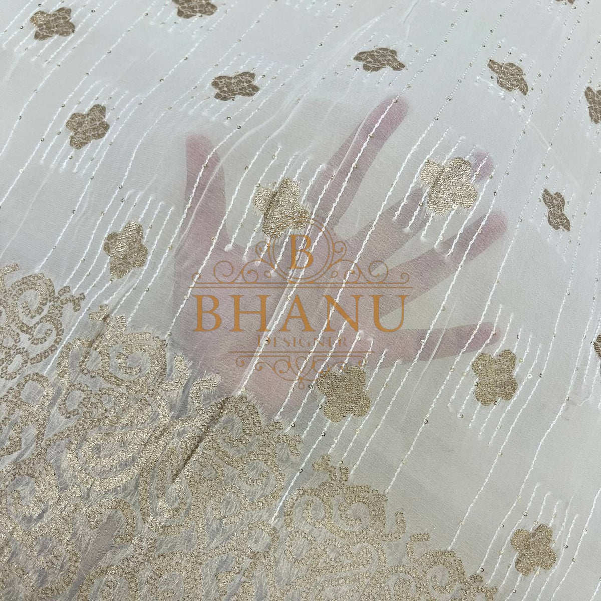 Ivory with gold butti and a worked border - fabric by the metre