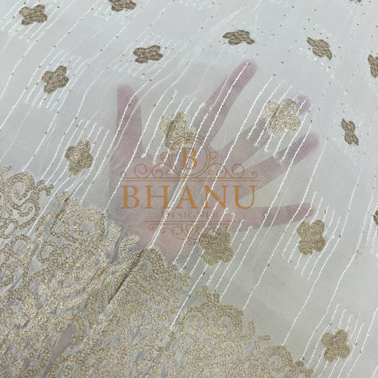 Ivory with gold butti and a worked border - fabric by the metre