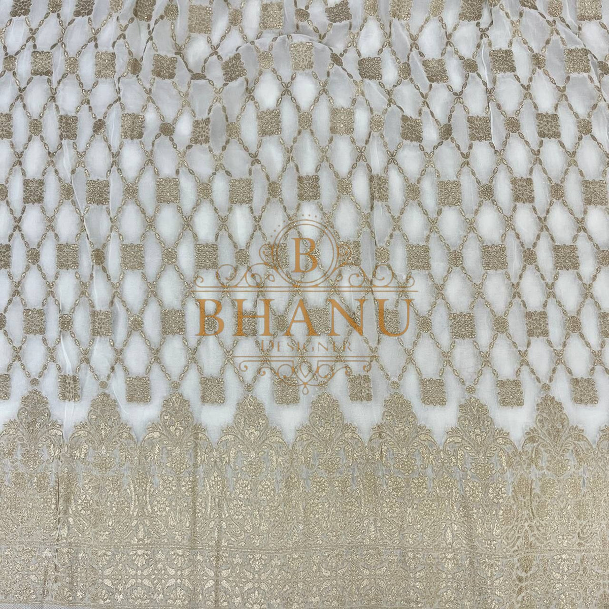 Ivory with gold lattice above a woven border - fabric by the metre