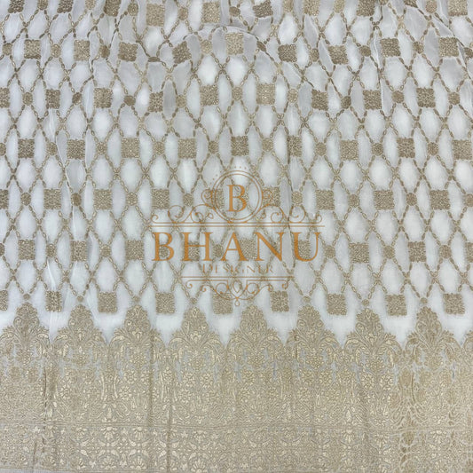 Ivory with gold lattice above a woven border - fabric by the metre