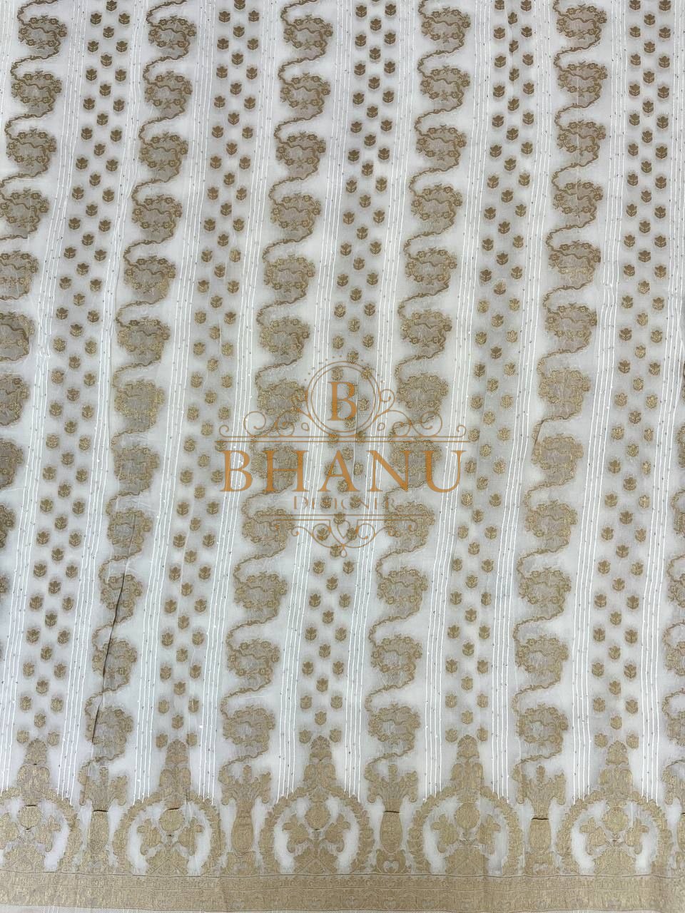Ivory with gold columns and a scalloped hem - fabric by the metre