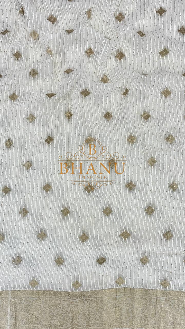 Ivory with gold butti and a gold hem - fabric by the metre