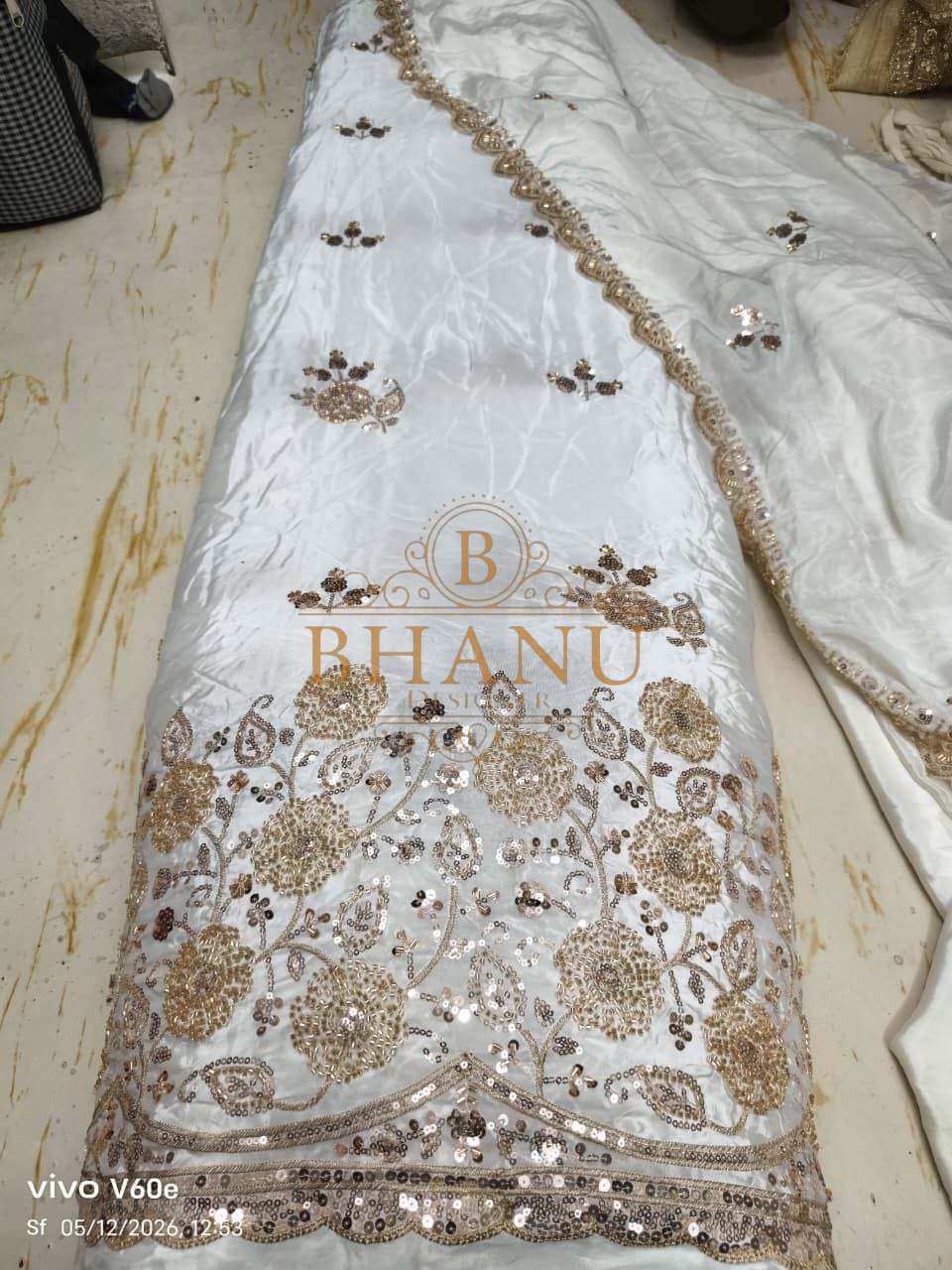 White satin with a gold sequin hem - fabric by the metre