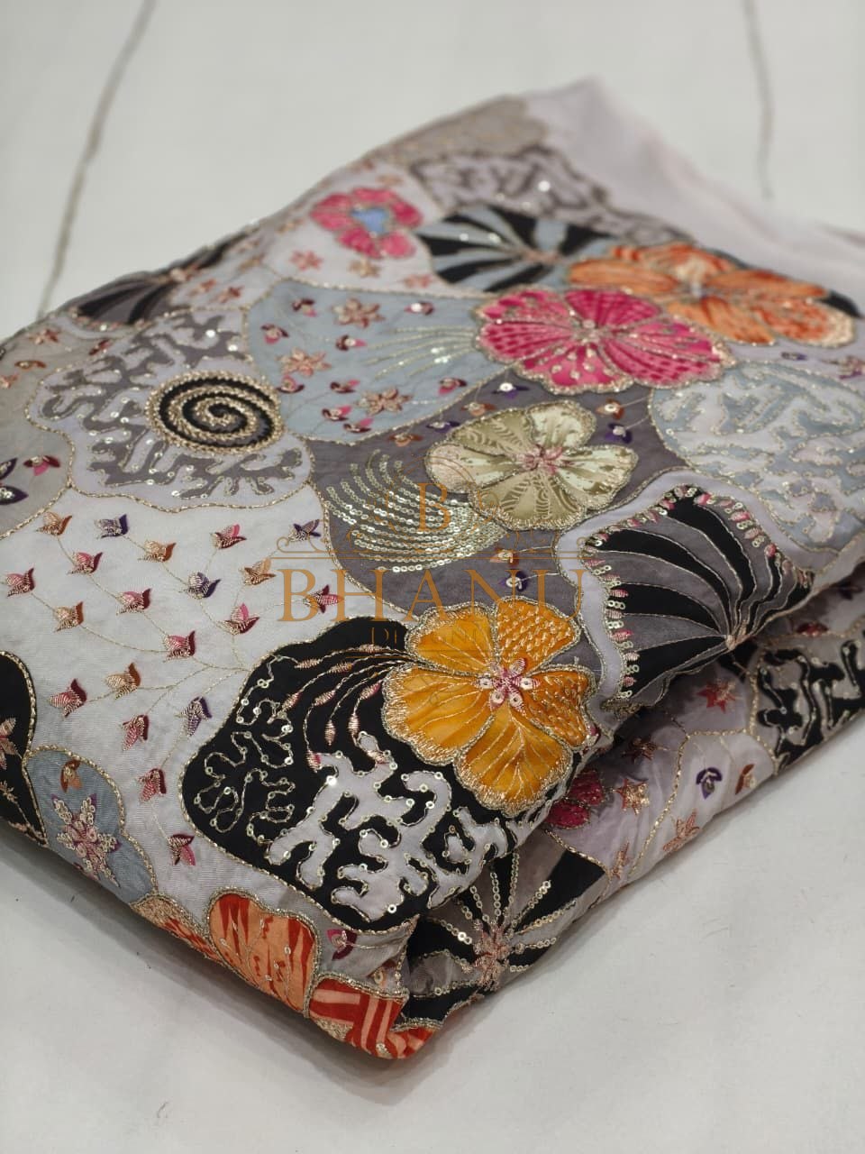Grey with black and orange floral work - fabric by the metre